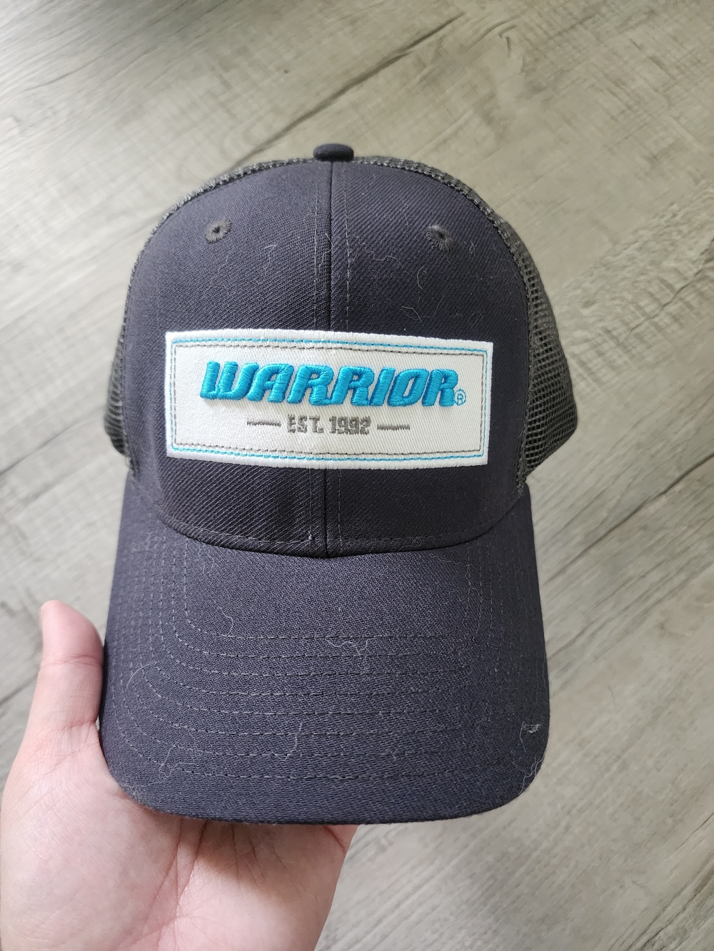 Black Trucker Hat with Teal Embroidered Patch